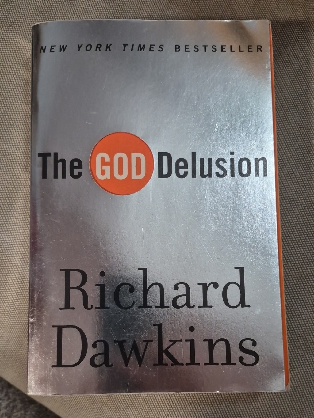 The God Delusion by Richard Dawkins - Silver & Orange Cover